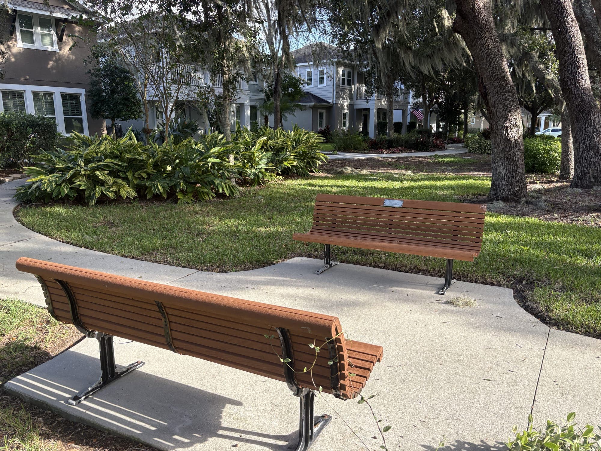 Both benches facing each other across a small round lawn.