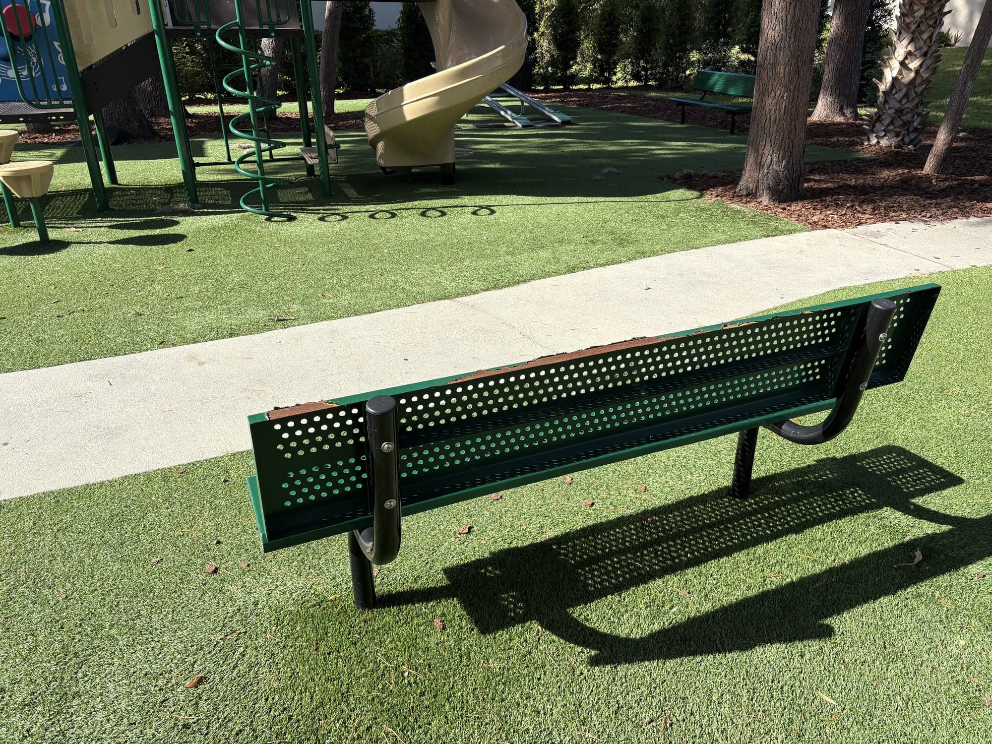 The bench from behind, looking over the path to the playground.