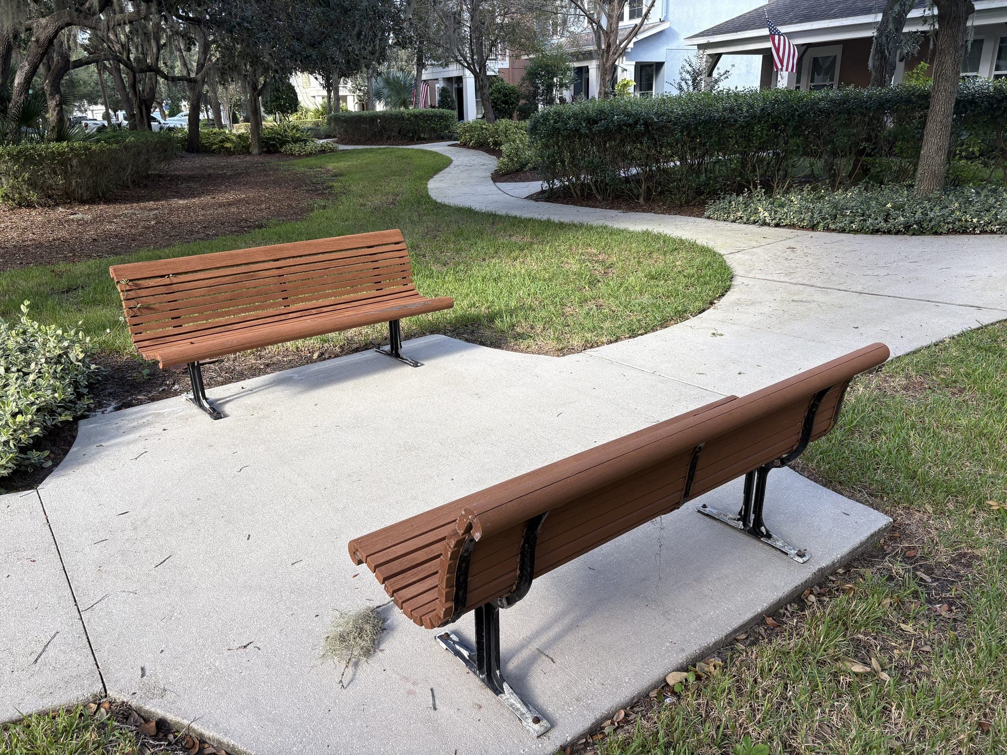 The bench in front, with the second bench across the lawn and a path curving behind.